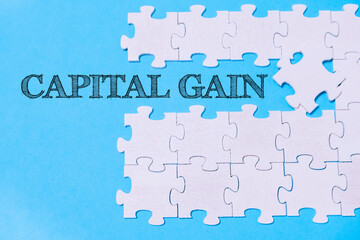 A jigsaw puzzle with the word Capital Gain written on it