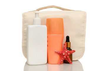 Women's cosmetics in a compact bag for travel. On a white background.