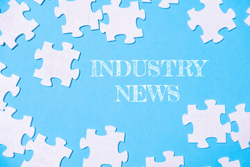A jigsaw puzzle with the word Industry News written in white