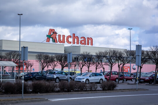 Wroclaw, Poland - February 19, 2022: French supermarket Auchan and a parking lot in front of the shopping centre building.