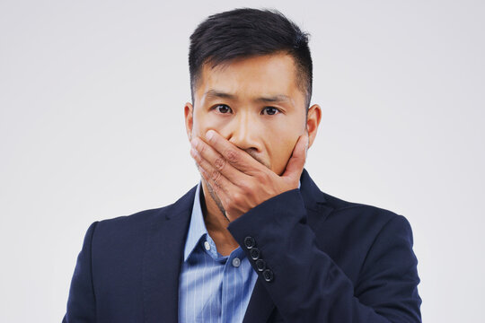 Studio portrait, businessman and shock for mistake with wow, gossip news and drama or secret announcement. Asian male worker, surprised and oops emoji for promotion and reaction by white background