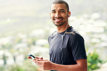 Fototapeta premium Fitness, music and phone with portrait of man outdoor in nature for health, marathon or wellness. Exercise, training and smile with happy runner in park for cardio, physical improvement or workout