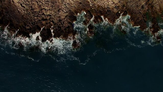 Sea surf hits the rock. Aerial view. High quality 4k footage