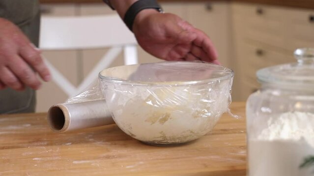 a male chef prepares the dough for making kutab