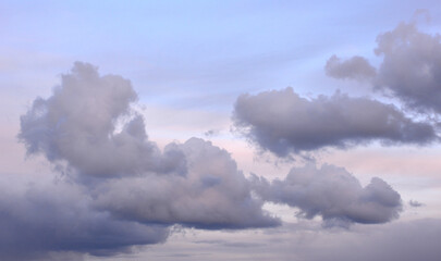 gray and purple clouds with blue and pink sunset sky 