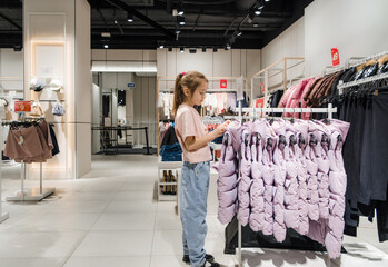 Young Girl Looking at Clothes in a Store