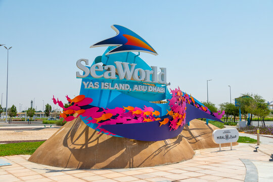 Abu Dhabi, UAE - March 22, 2024: SeaWorld Yas Island sign with colorful fish decorations on a sunny day in Abu Dhabi