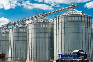 Metal tanks for storage of grain. Modern granary elevator. Loading and transportation of...