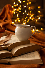 books, leaves, coffee cup and bokeh lights