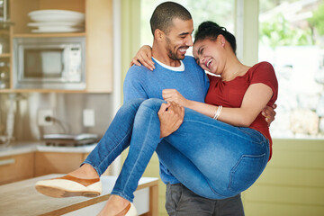 Happy, man and lifting woman in kitchen with love, care and together with support in apartment....