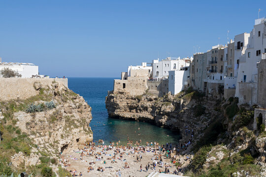Polignano a Mare Famous Beach, Lama Monachile, famous beach in seaside city in Bari, Puglia, Italy. European summer.
