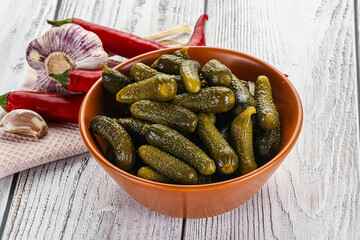 Marinated small cucumbers in the bowl