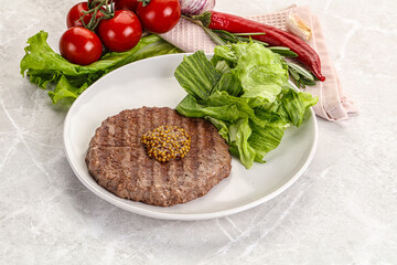 Frilled beef burger cutlet with iceberg