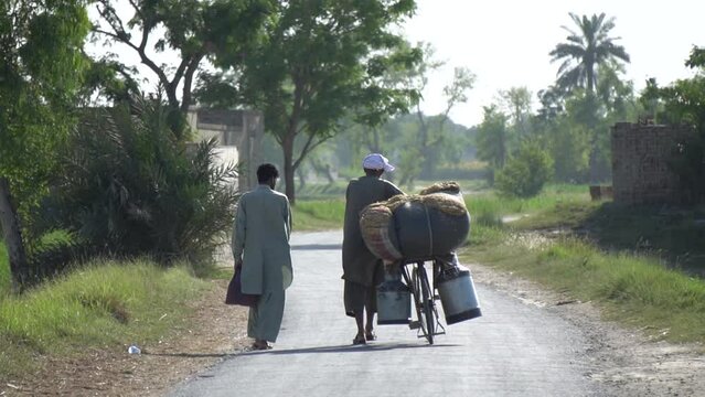 Indigenous people of pakistani rural life representing the daily routine of life, two people going on their daily working lifestyle in Punjab, Pakistan. Slow Motion 