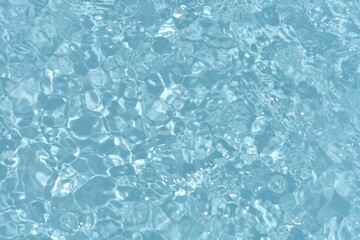 Blue water with ripples on the surface. Defocus blurred transparent blue colored clear calm water...