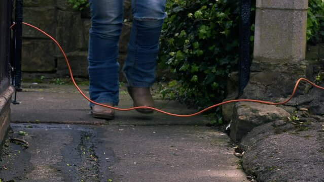 Woman trips over cable on pathway