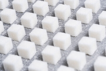 Refined sugar cubes are laid out in clear geometric lines.