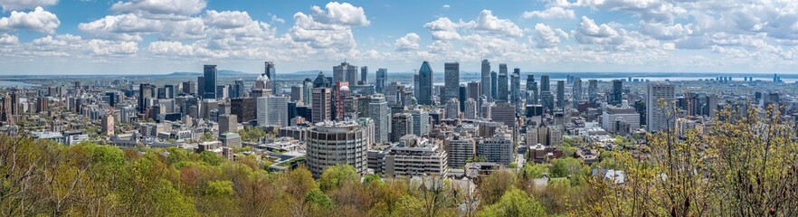 Large high resolution panorama view of downtown Montreal skyline on a beautiful spring day, province of Quebec, Canada. High quality photo taken from Kondiaronk Belvere lookout, Mount Royal (May 2024)