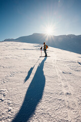 Mountaineer backcountry ski walking ski alpinist in the mountains. Ski touring in alpine landscape...