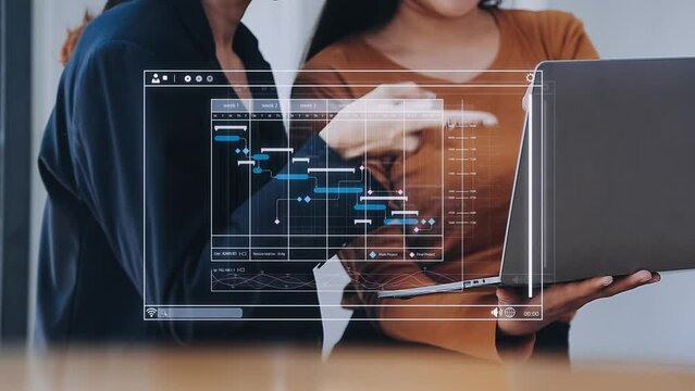 Project manager working with Gantt chart schedule to plan tasks and deliverables. Scheduling activities with a planning software, Corporate strategy for finance, operations, sales, marketing.