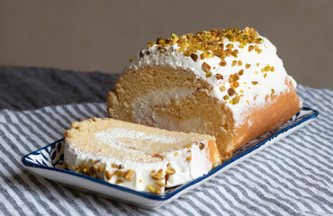Piece of cake with cream and pistachios.