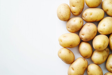 A bunch of potatoes are piled up on a white background