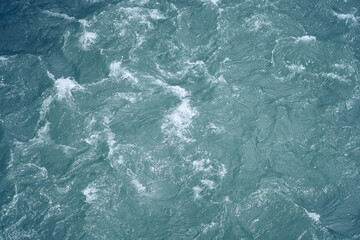Ripples and waves on the water. Beautiful background with blue water and a place to copy. Close-up...