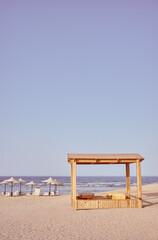 Retro toned photo of a beach with  beach gazebo, sun loungers and umbrellas, Egypt.