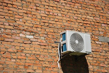 Old red brick wall with air conditioning on a sunny day