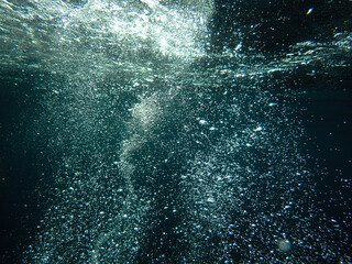 Bubbles under the sea in the crystal clear green sea water. Mediterranean bubbles. Real image very...