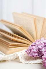 Old book and lilac flower.