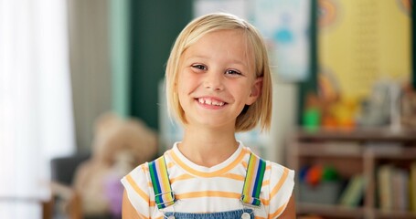 Girl, child and face or happy in classroom for education, knowledge or fun learning with confidence. Student, person and portrait with smile at kindergarten for studying, pride and academy or school