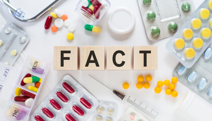 Wooden Blocks Spelling FACT Amidst Various Medication Pills and Capsules