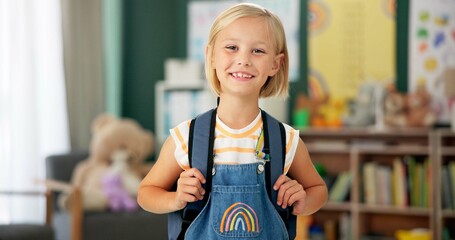 Happy, face and child in classroom for education, learning and ready for morning kindergarten. Smile, school and portrait of girl or student with knowledge, studying and pride for academic lesson © peopleimages.com