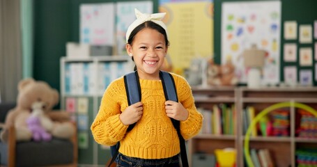 Child, face and smile in classroom with backpack for back to school excited with education,...