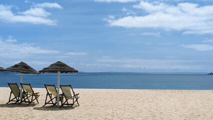 Tranquil Scene of Beach Chairs and Umbrellas on Sandy Shore with Ocean View
