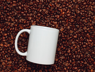 White mockup mug on coffee beans, top view. White template coffee mug for logo, print, gift, branding and design