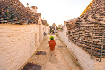 Trulli of Alberobello, Puglia, Italy. town of Alberobello with trulli houses among green plants and...