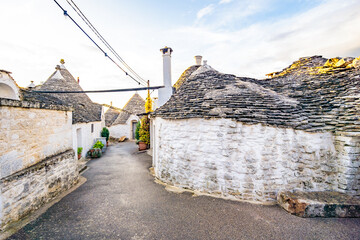 Trulli of Alberobello, Puglia, Italy. town of Alberobello with trulli houses among green plants and...