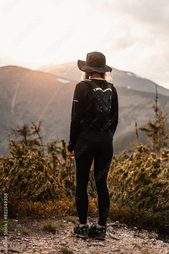 Wall mural young traveler hiking girl with backpacks. hiking in mountains. tourist traveler. hiking in slovakia