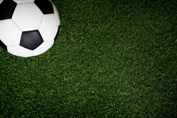 top view of football on green field , soccer ball on grass