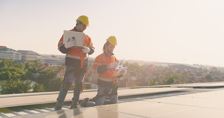 Two engineers solar technicians in reflective gear discussing working examine solar installations...