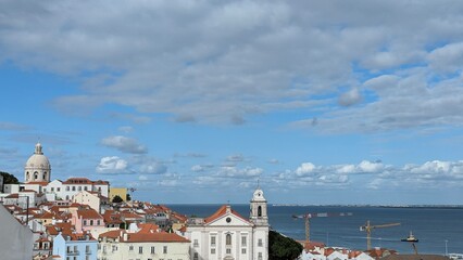 Fototapeta premium Panoramic view of Lisbon, Portugal with cityscape, buildings and boats on the Tagus River