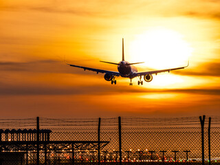 Airplane landing at sunset on Barcelona airport