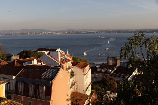 View of boats on the Tagus River in Lisbon, Portugal at dusk from Sao Jorge castle.
