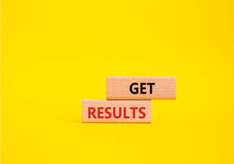 Get results symbol. Wooden blocks with words Get results. Beautiful yellow background. Business and Get results concept. Copy space.