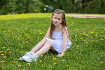 Portrait of a little blonde girl, summer outdoor