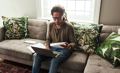 Documents, investment and laptop with black man on sofa in living room of home for bank or payment....