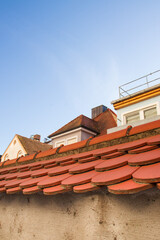 edge of an antique tiled roof, red tiles