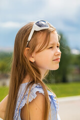 Portrait of a little blonde girl, summer outdoor